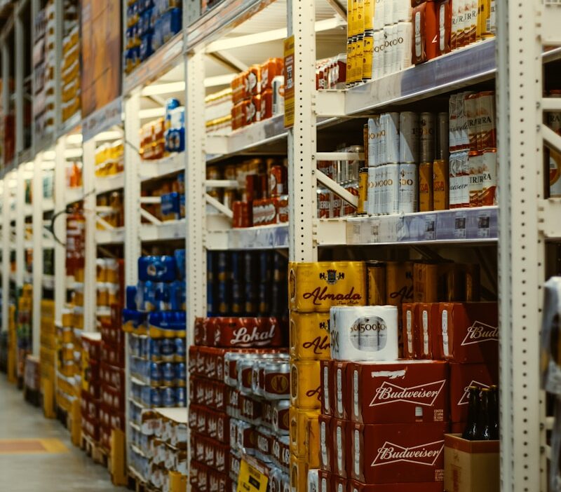 red and white labeled cans on shelf